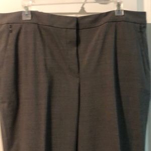 Dress pants with zipper pockets at hip.